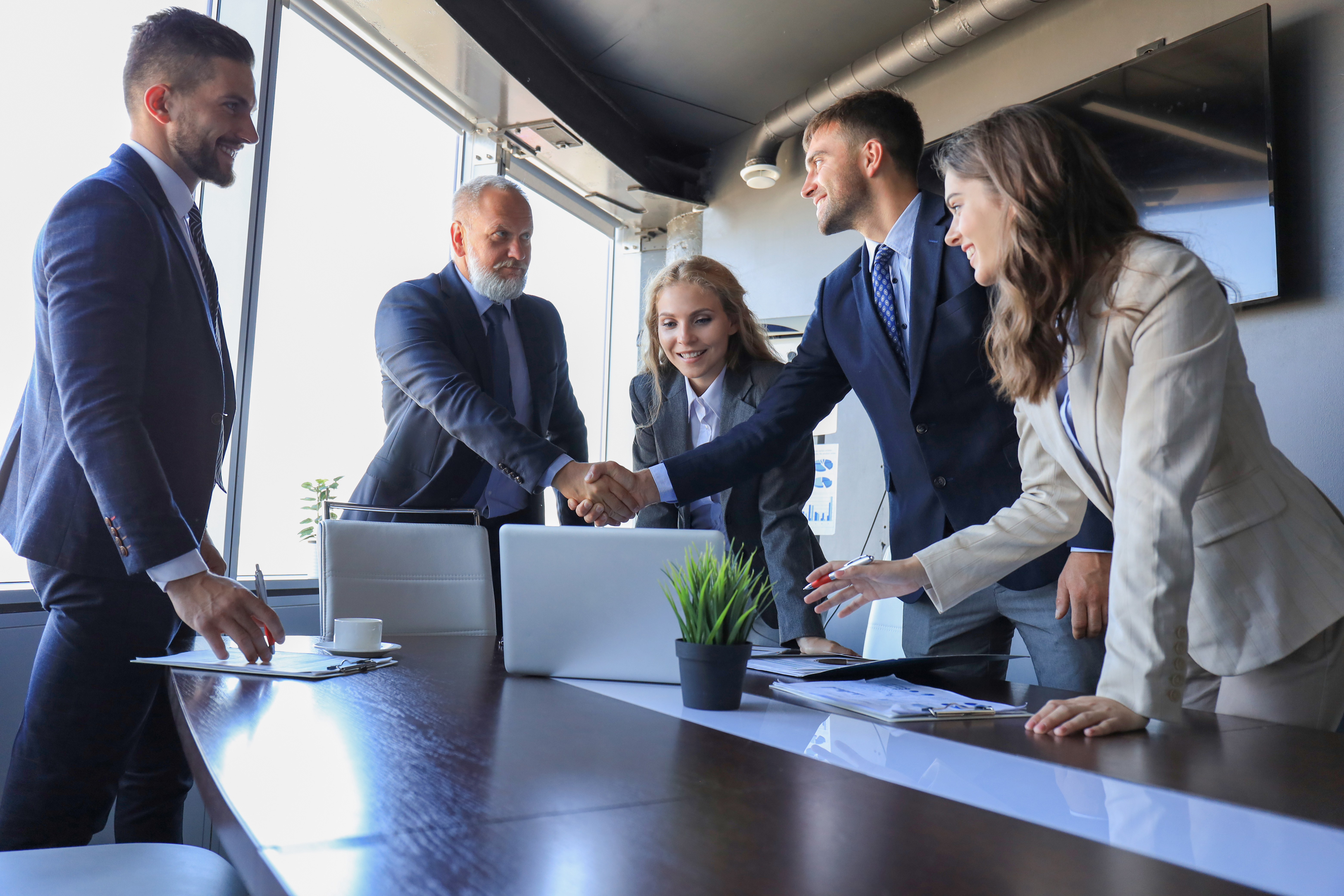 Business people shaking hands, finishing up a meeting.